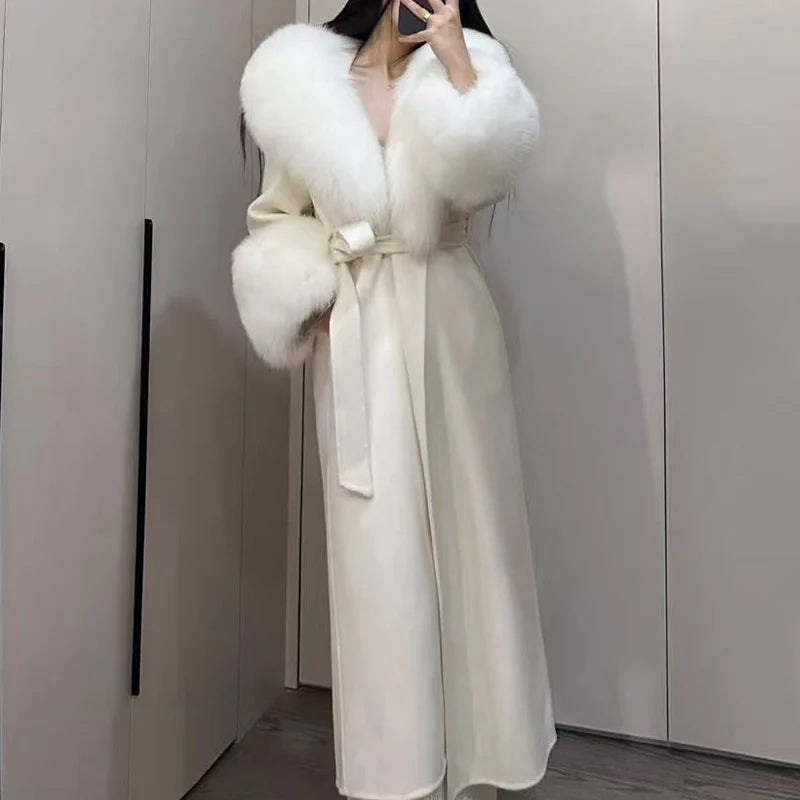 Women's elegant cream-colored long wool coat with faux fur collar and cuffs, featuring a self-tie belt for a stylish winter look