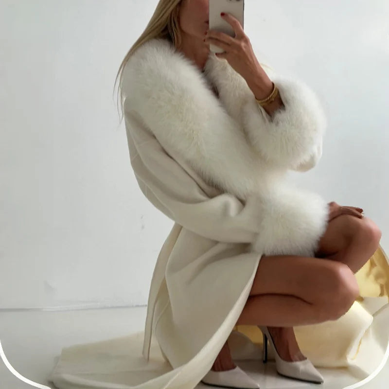Women's elegant cream-colored long wool coat with faux fur collar and cuffs, featuring a self-tie belt for a stylish winter look