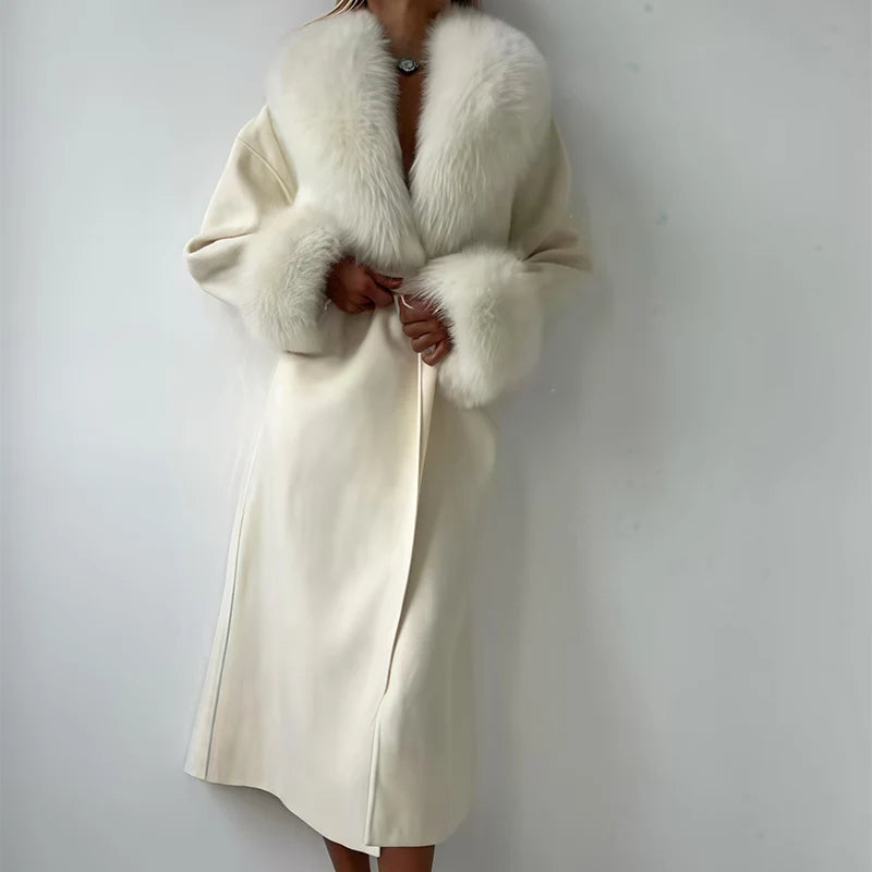 Women's elegant cream-colored long wool coat with faux fur collar and cuffs, featuring a self-tie belt for a stylish winter look